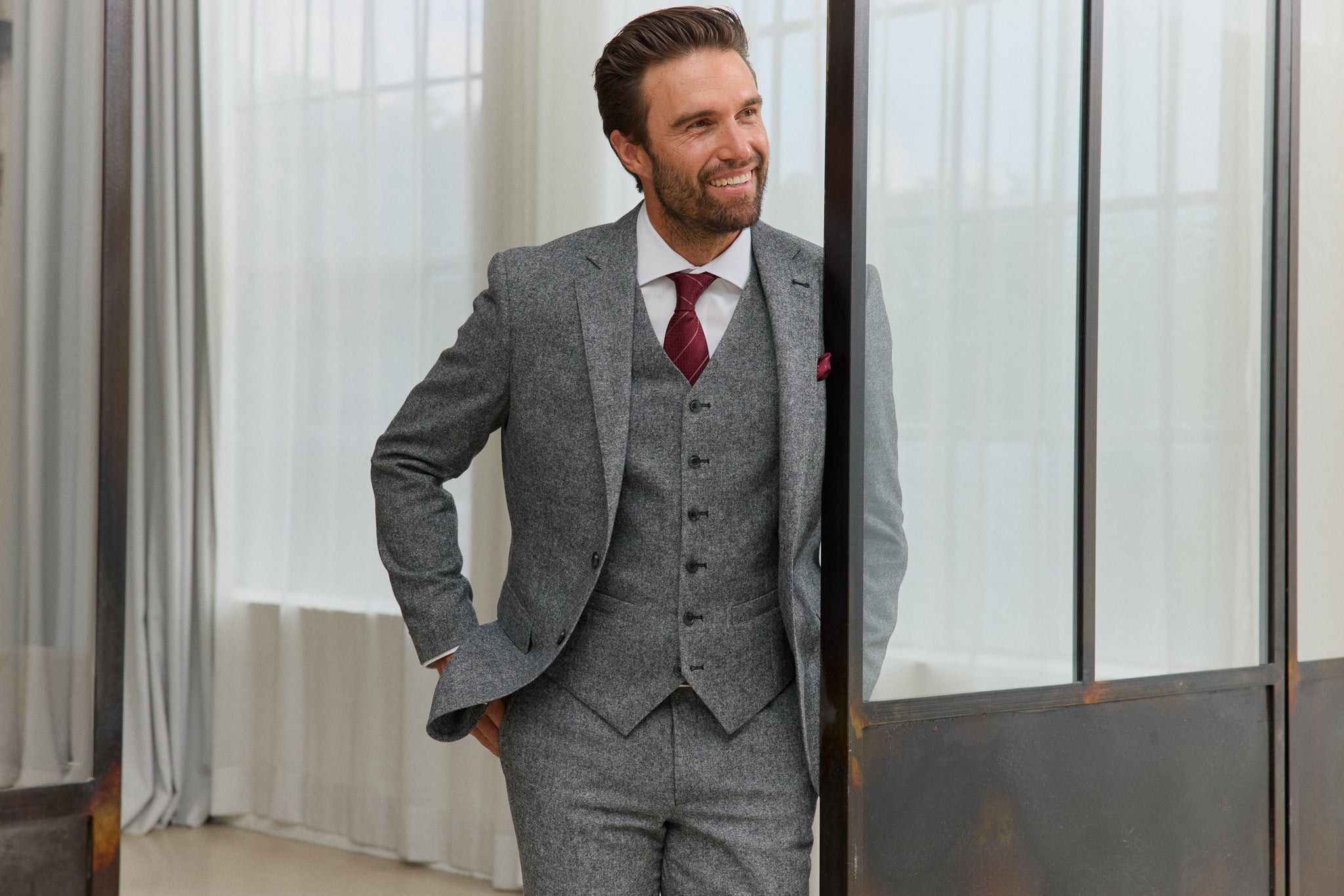 Mann im grauen Anzug mit roter Krawatte